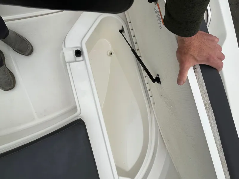 Slide: The Image of 2021 Bayliner Trophy boat storage compartment with open hatch and visible interior. - 9
