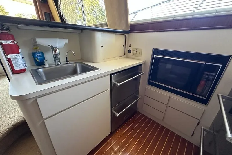 Slide: The Image of Interior of 1988 Hatteras 48 Convertible yacht with cozy seating and kitchenette. - 10