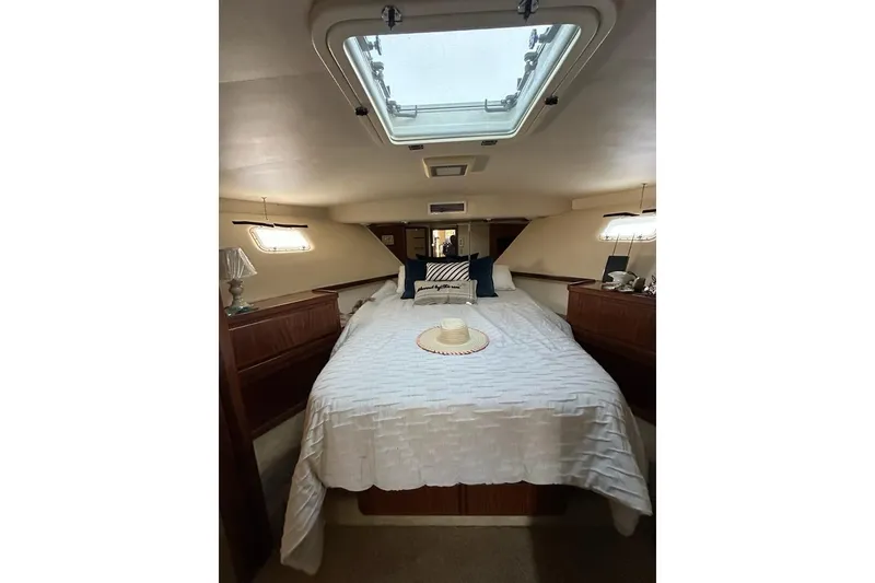 Slide: The Image of Interior of 1988 Hatteras 48 Convertible yacht with modern kitchen and wood accents. - 12