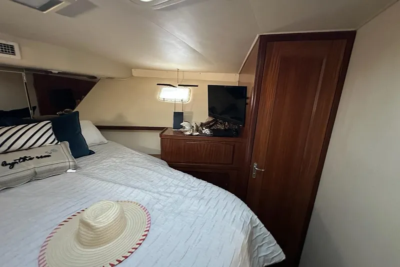 Slide: The Image of 1988 Hatteras 48 Convertible yacht kitchen with modern appliances and wood accents. - 13