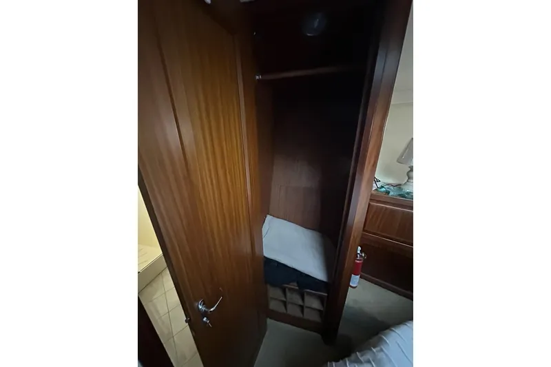 Slide: The Image of 1988 Hatteras 48 Convertible yacht kitchen with sink, microwave, and wooden flooring. - 15