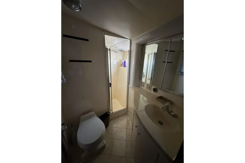 Slide: The Image of Interior view of 1988 Hatteras 48 Convertible yacht, featuring wooden walls and a cozy hallway. - 16