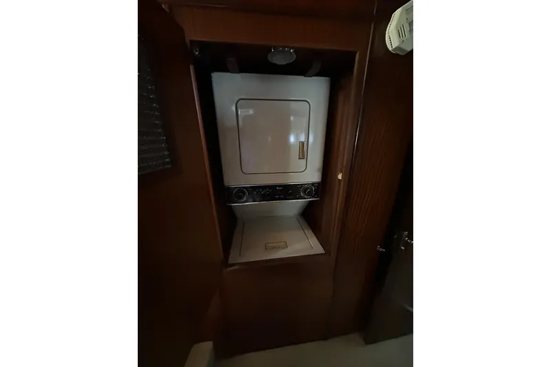 Slide: The Image of 1988 Hatteras 48 Convertible yacht bedroom with skylight and elegant decor. - 17