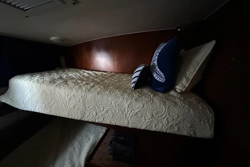 Slide: The Image of Cozy bedroom interior of 1988 Hatteras 48 Convertible yacht with nautical decor. - 19