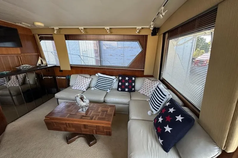 Slide: The Image of 1988 Hatteras 48 Convertible yacht docked at marina, clear sky background. - 2