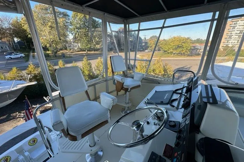 Slide: The Image of Cozy cabin bed in 1988 Hatteras 48 Convertible yacht with decorative pillows. - 25