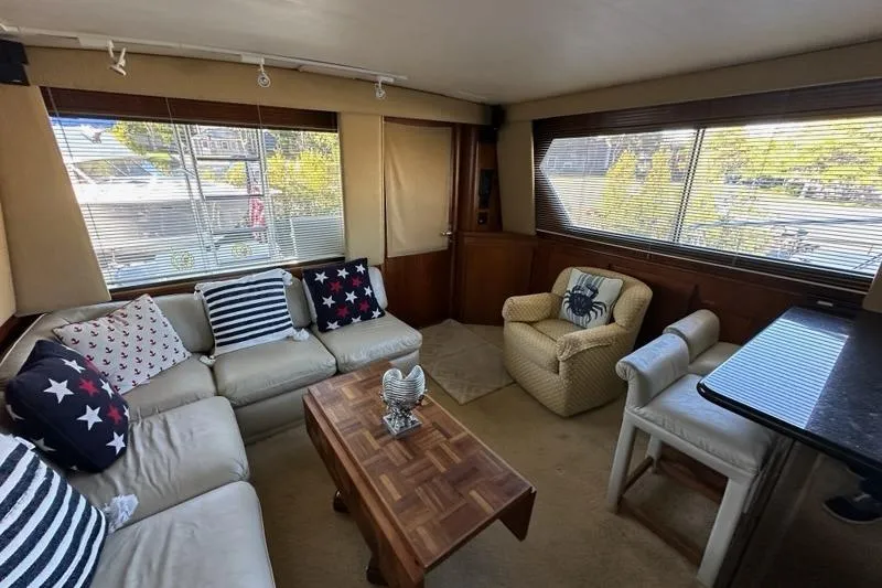 Slide: The Image of 1988 Hatteras 48 Convertible yacht docked near waterfront apartments. - 3