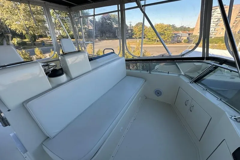 Slide: The Image of Helm of 1988 Hatteras 48 Convertible yacht with navigation instruments and steering wheel. - 32