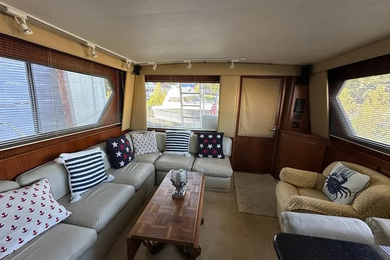 Slide: The Image of 1988 Hatteras 48 Convertible yacht docked in marina, clear sky background. - 4