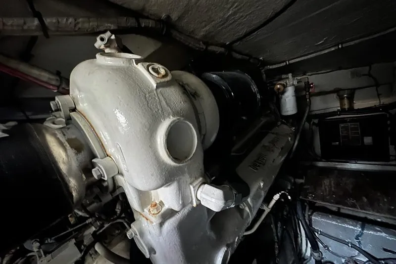 Slide: The Image of Engine room of 1988 Hatteras 48 Convertible yacht, showcasing dual engines and exhaust systems. - 40