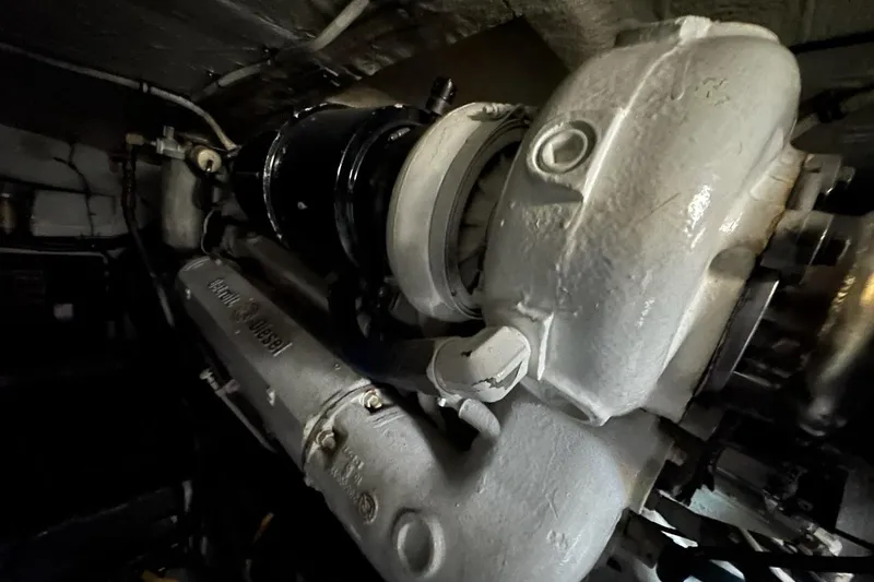 Slide: The Image of Engine room of 1988 Hatteras 48 Convertible boat, showcasing mechanical components. - 41