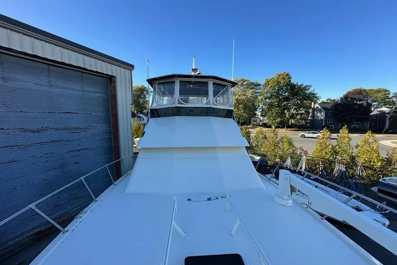 Slide: The Image of Engine room of 1988 Hatteras 48 Convertible with visible components and hoses. - 43