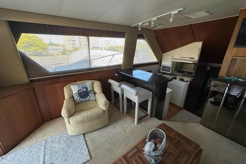 Slide: The Image of 1988 Hatteras 48 Convertible yacht docked near waterfront buildings. - 5