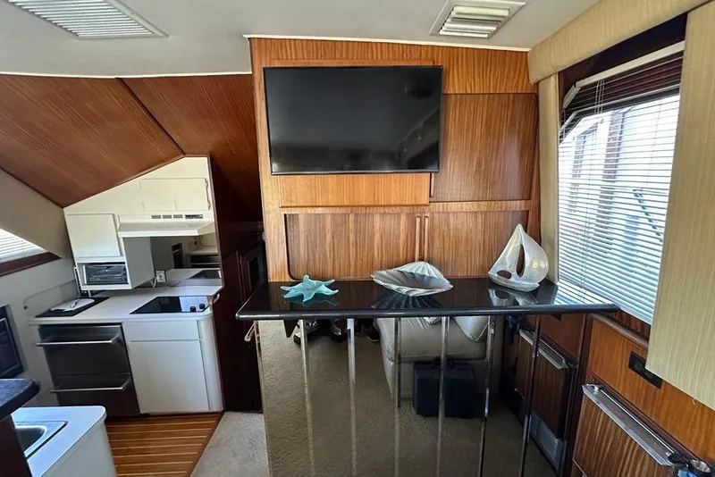 Slide: The Image of Luxurious interior of 1988 Hatteras 48 Convertible yacht with cozy seating and nautical decor. - 6