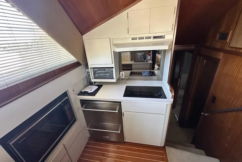 Slide: The Image of Interior of 1988 Hatteras 48 Convertible yacht with cozy seating and nautical decor. - 8