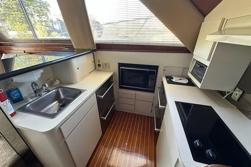 Slide: The Image of Interior of 1988 Hatteras 48 Convertible yacht with cozy seating and nautical decor. - 9