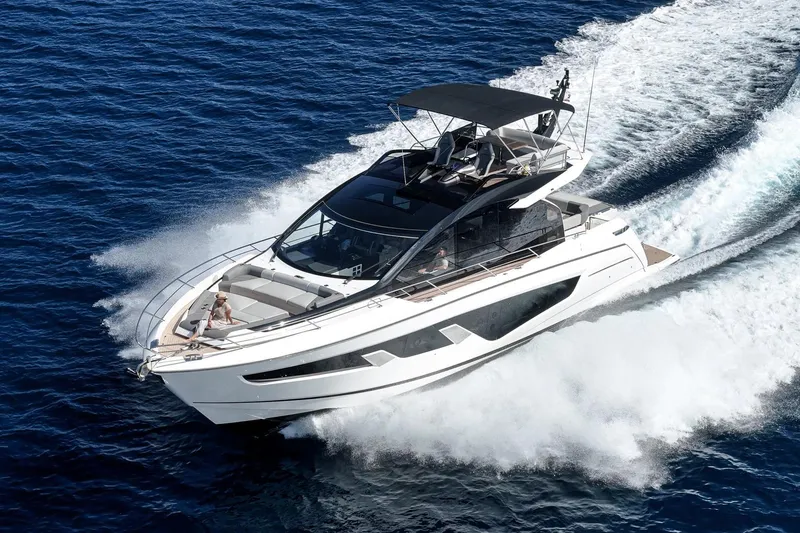The Image of 2023 Sunseeker 65 Sport Yacht cruising on open water, showcasing sleek design and luxury. - 0