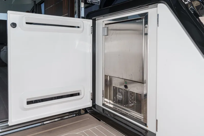 Slide: The Image of Open storage compartment on 2023 Sunseeker 65 Sport Yacht, showcasing sleek interior design. - 10