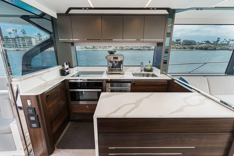Slide: The Image of Luxurious kitchen interior of 2023 Sunseeker 65 Sport Yacht with modern appliances and waterfront view. - 25