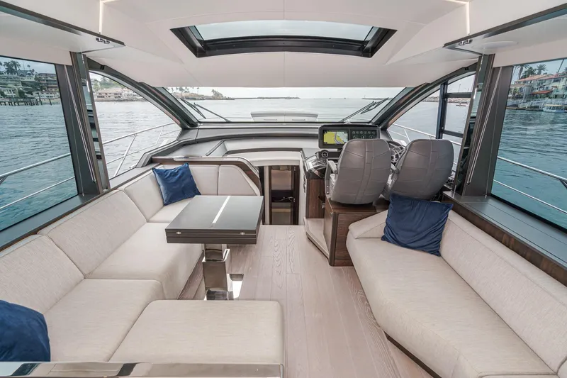 Slide: The Image of Luxurious interior of 2023 Sunseeker 65 Sport Yacht with panoramic windows and plush seating. - 28