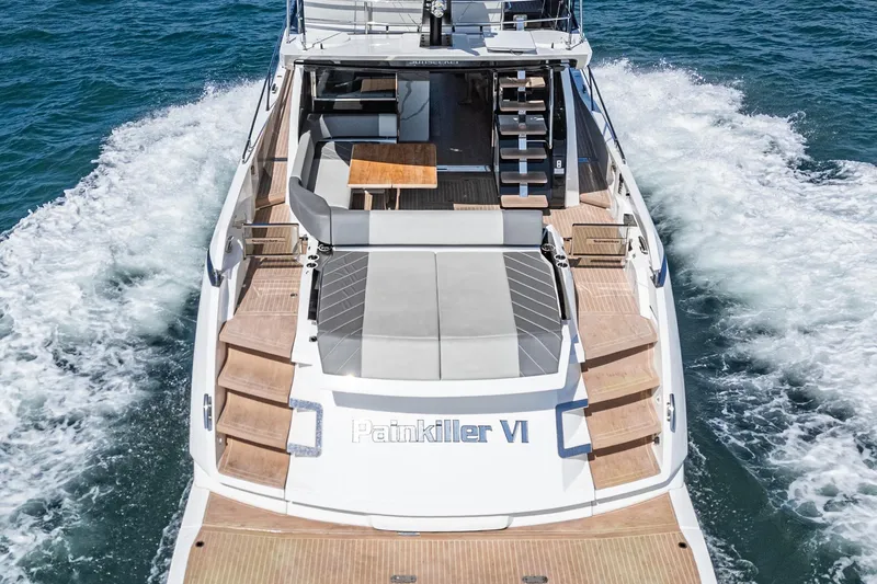 Slide: The Image of 2023 Sunseeker 65 Sport Yacht cruising on open water, rear view. - 5