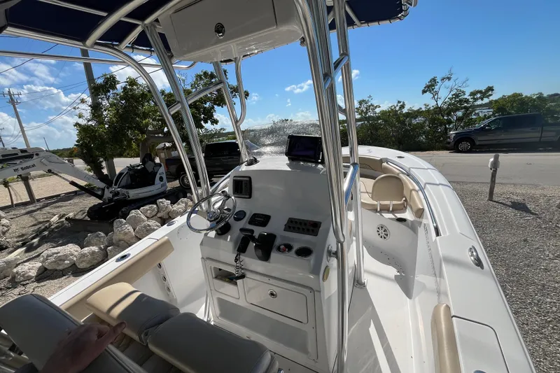 Slide: The Image of 2014 Sportsman Heritage 211 Center Console boat with steering wheel and control panel. - 11