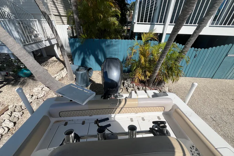 Slide: The Image of 2014 Sportsman Heritage 211 Center Console boat with outboard motor in a tropical setting. - 9