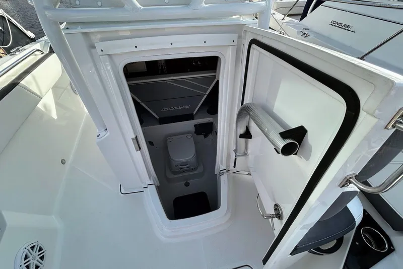 Slide: The Image of 2019 Blackfin 242 CC boat interior with open hatch and visible seating area. - 13