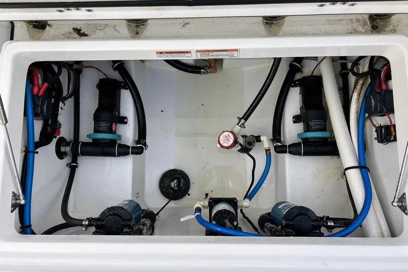 Slide: The Image of 2019 Blackfin 242 CC boat compartment with pumps and wiring. - 15