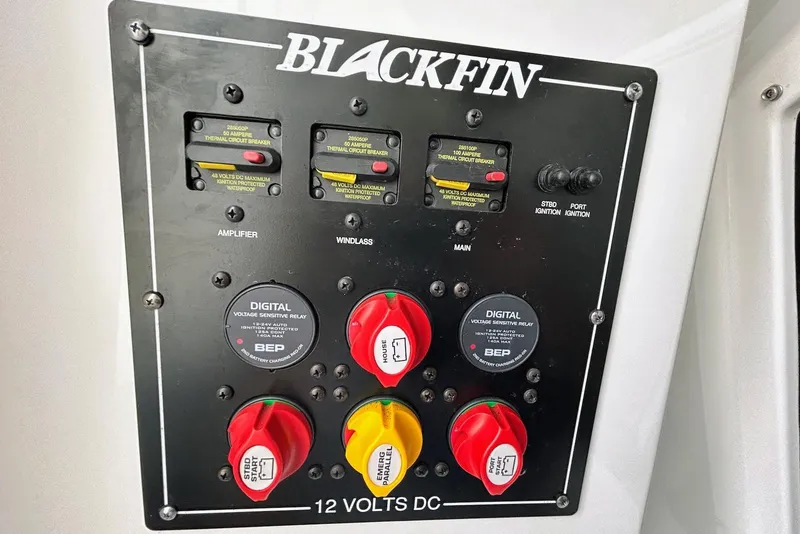 Slide: The Image of Control panel of 2019 Blackfin 242 CC boat with circuit breakers and voltage relays. - 19
