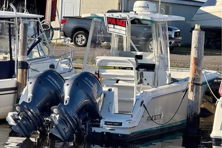 Slide: The Image of 2019 Blackfin 242 CC boat console with steering wheel, navigation screens, and controls. - 5