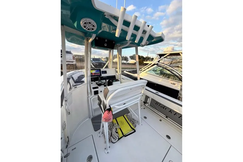 Slide: The Image of 2019 Blackfin 242 CC boat docked at marina, front view. - 6