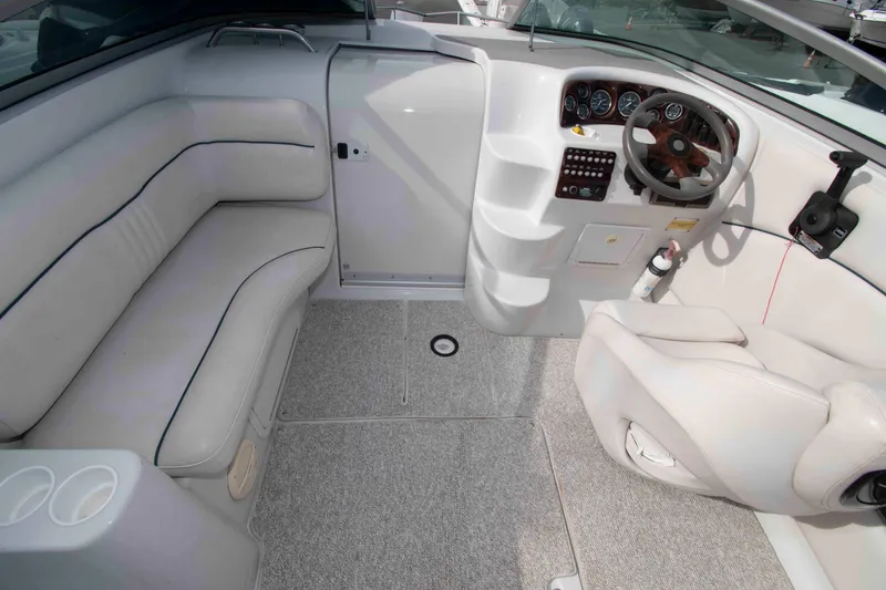 Slide: The Image of 2004 Crownline 235 CCR boat interior with white seating and steering console. - 3
