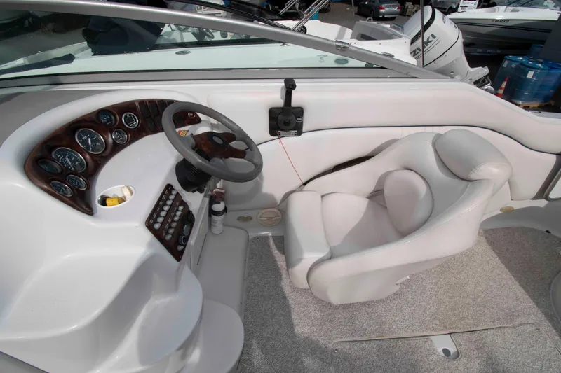 Slide: The Image of 2004 Crownline 235 CCR boat cockpit with steering wheel and instrument panel. - 4