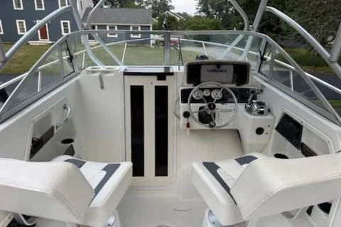 Slide: The Image of 2000 Boston Whaler 23 Conquest boat interior with dual seats and steering console. - 12