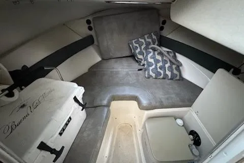 Slide: The Image of 2000 Boston Whaler 23 Conquest cabin interior with cushions and storage. - 13