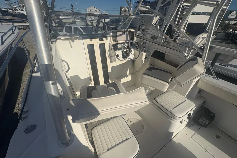 Slide: The Image of 2000 Boston Whaler 23 Conquest boat interior with steering wheel and seating. - 14
