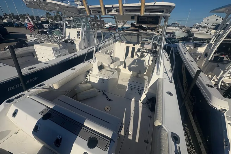 Slide: The Image of 2000 Boston Whaler 23 Conquest boat interior with seating and steering wheel, docked at marina. - 15