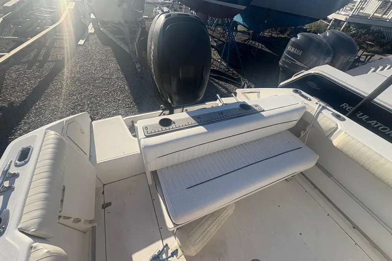 Slide: The Image of 2000 Boston Whaler 23 Conquest boat interior with seating and outboard motor. - 16