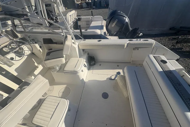 Slide: The Image of 2000 Boston Whaler 23 Conquest boat interior with seating and steering wheel. - 17