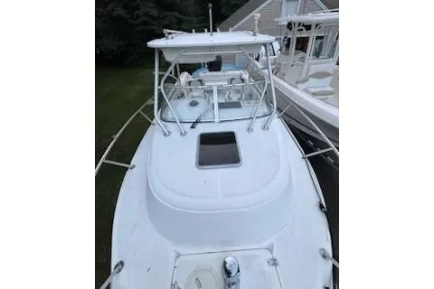 Slide: The Image of 2000 Boston Whaler 23 Conquest boat, white exterior, docked, view from bow. - 18