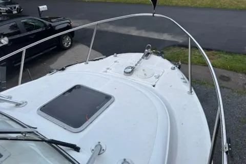 Slide: The Image of 2000 Boston Whaler 23 Conquest boat deck with railing and hatch. - 19