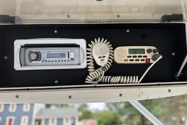 Slide: The Image of 2000 Boston Whaler 23 Conquest boat dashboard with radio and communication equipment. - 20