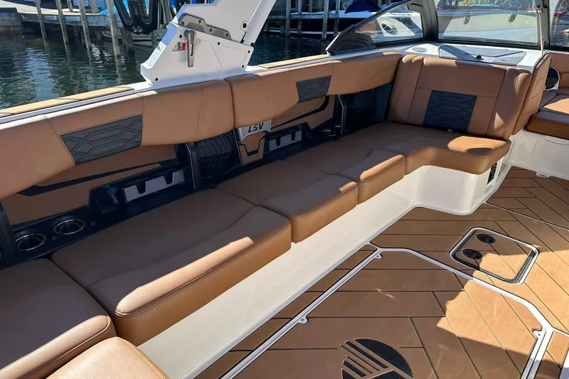Slide: The Image of 2024 Malibu Wakesetter 25 LSV interior with brown leather seating and stylish design. - 11