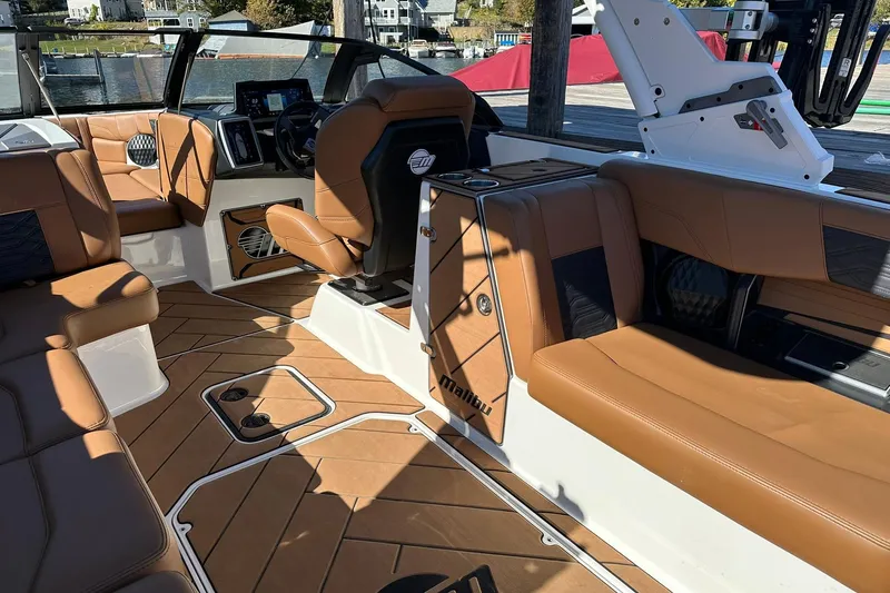 Slide: The Image of 2024 Malibu Wakesetter 25 LSV interior with luxurious tan seating and modern dashboard. - 12