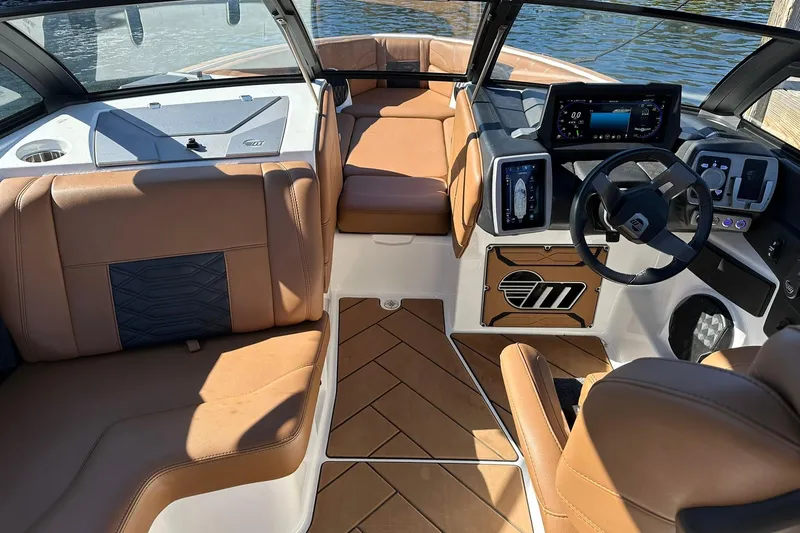 Slide: The Image of 2024 Malibu Wakesetter 25 LSV interior with luxurious seating and advanced dashboard controls. - 13