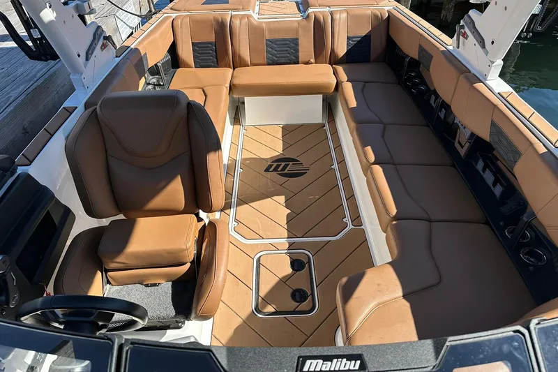 Slide: The Image of 2024 Malibu Wakesetter 25 LSV interior with luxurious brown seating and sleek design. - 18