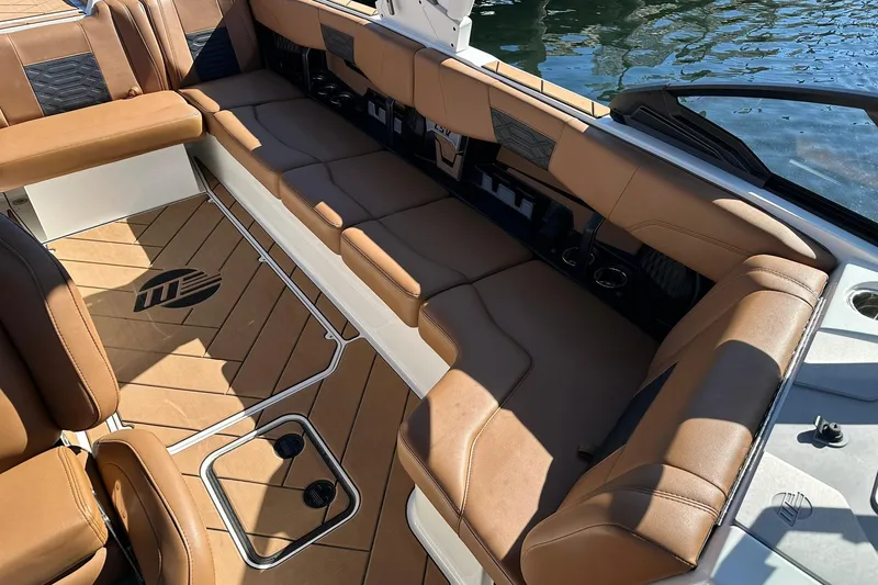Slide: The Image of 2024 Malibu Wakesetter 25 LSV interior with luxurious brown seating and stylish flooring. - 19