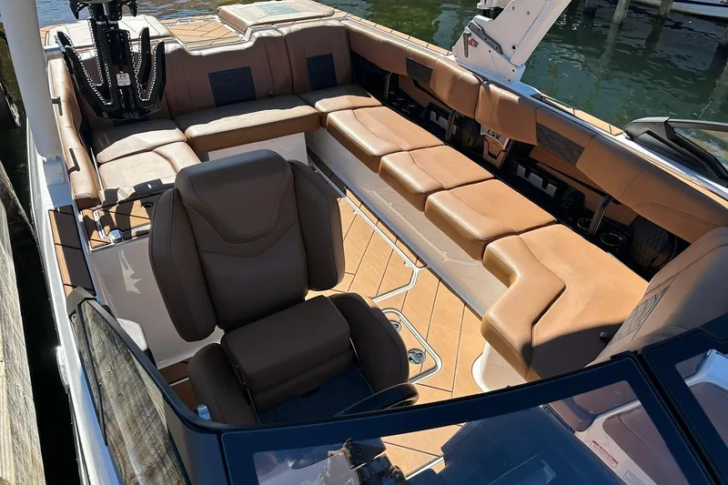 Slide: The Image of 2024 Malibu Wakesetter 25 LSV interior with luxurious brown seating and modern design. - 6