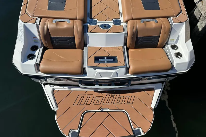 Slide: The Image of 2024 Malibu Wakesetter 25 LSV boat with brown seating and deck. - 8